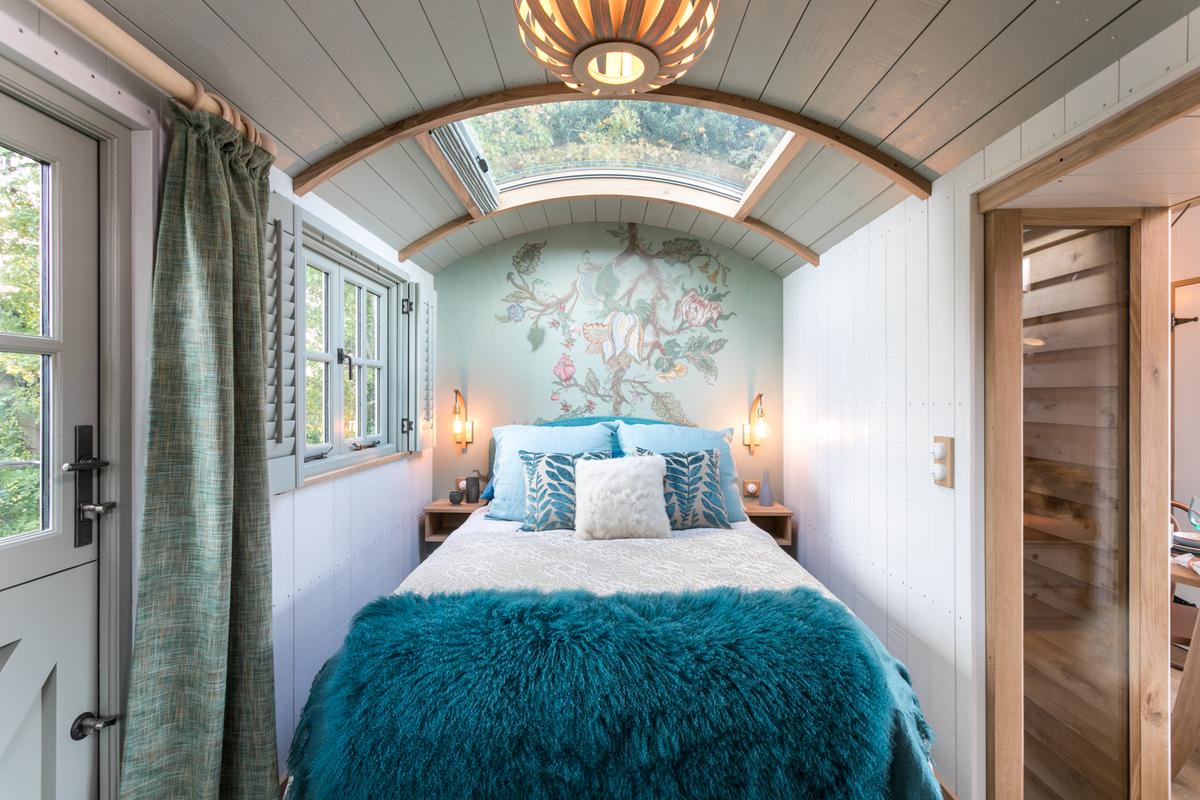 Interior detail of a Blackdown shepherd hut showing curved oak ceiling, skylight and joinery